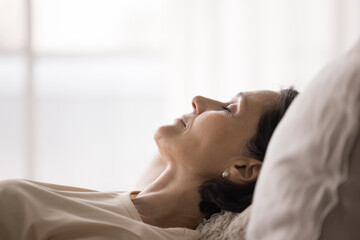 Closeup shot carefree senior woman sleeping on back on pillow