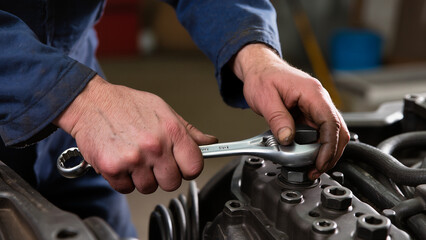 mechanic changing car engine