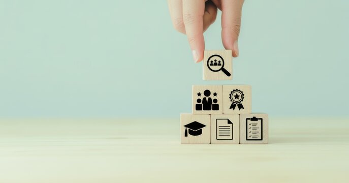 Concept Cubes of Business: A hand carefully places a cube atop a pyramid of blocks, each etched with symbols representing key business concepts, signifying strategy and planning.