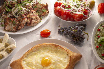 Baked boatshaped cheese delight, Warm baked bread filled with golden egg and cheese, Cozy communal table serving boatshaped khachapuri with melted cheese