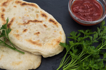 Homemade flatbread with herbs and tomato sauce