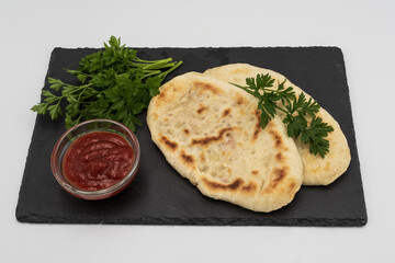 Homemade flatbread with herbs and tomato sauce