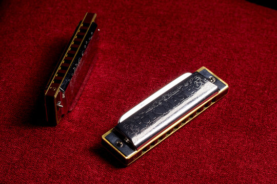 harmonica on a red background, close-up.
