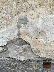 Old broken wall with vintage rusty vent.