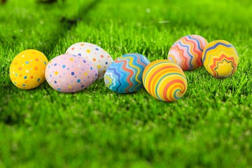 Easter eggs painted in different colors on the grass