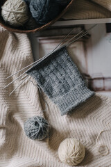 Hand knitting with needles and yarn balls. Concept for handmade and hygge slow life.