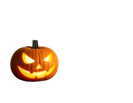 A carved, lit pumpkin with an eerie, toothy grin against a stark, black background