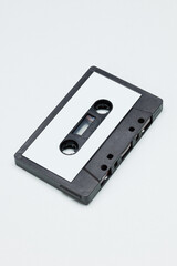 Black plastic audio cassette tape with blank label. Vintage Retro acoustic.