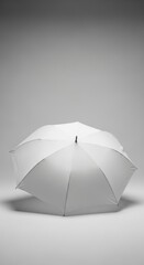Elegant plain white umbrella isolated on soft graduated gray background