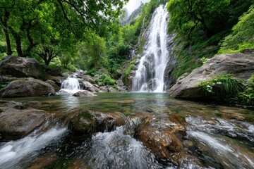 Fototapeta premium Tranquil Waterfall Cascading into Rocky Stream