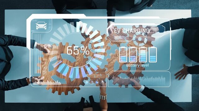A business team collaborates on electric vehicle charging strategies, using data analytics to monitor battery levels, showcasing innovation in a modern office setting. Raster