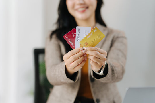 Card Offering: A professional showcases a selection of credit cards, symbolizing financial tools for diverse transactional needs, suggesting convenience, and opportunity.