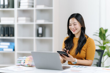 Focused and Flourishing: A young professional finds focus while working on a laptop. Capturing the essence of dedication and productivity in a well-lit office