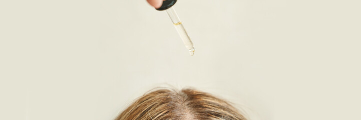 Haircare routine with oil dropper for healthy scalp and nourished hair.