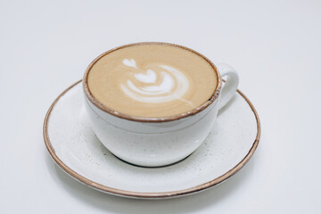 A white cup of freshly brewed coffee