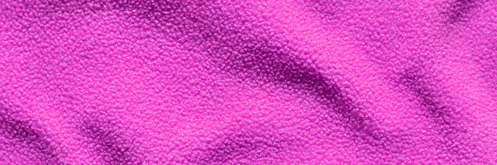 Vibrant pink wool texture with soft and cozy fabric material in close-up detail.