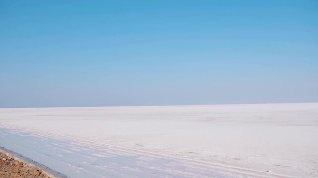 Salt flats at rann of Kutch during day. White desert of Kutch in Gujarat, India. Expansive salt marsh of The Great Rann of Kutch. Tranquil Nature landscape. Rann Utsav festival at Kutch during winter.