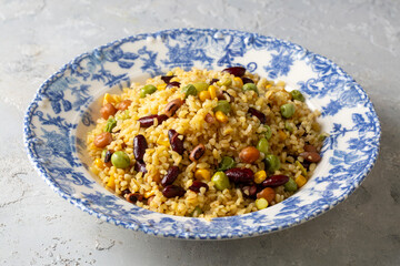 Bulgur pilaf with legumes; with peas, beans and corn kernels.