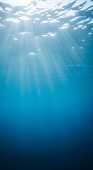Obraz premium Underwater sun rays illuminate clear blue ocean water tranquil serene marine environment light penetrating through surface creating beautiful aquatic scene peaceful deep sea background