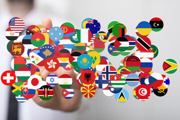 A hand gently holding various flags representing nations, symbolizing global unity, international...