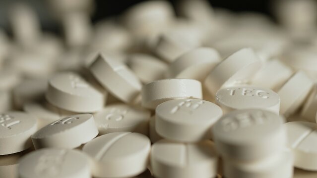 Powder drugs pressed in pills shape Stash of Oxy, Meth, Fentanyl or synthetic opioid drugs, seized by police or security, illegal drugs trafficking.