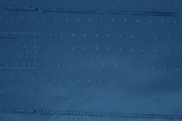 Abstract background of metal paneling with rivets.