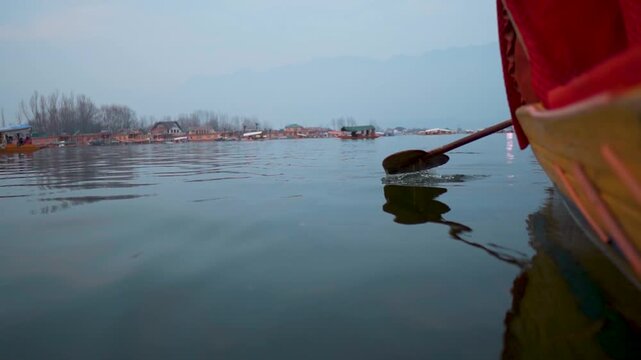 Unique heart shaped paddle to maneuver Shikara on Dal Lake at foggy winter morning in Srinagar, Jammu and Kashmir, India. Transportation for locals and tourists in Dal lake, Kashmir. Travel concept.