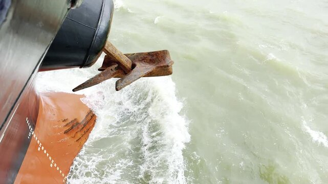 Real footage of cargo ship dropping anchor &mdash; chain running, splashes, and full anchoring process filmed onboard. Filmed from multiple angles, showing authentic seamanship and shipboard operations.
