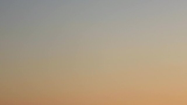 Warm orange dawn gradient sky before sunrise with gentle morning light for elegant background