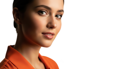 A close-up portrait of a woman with a soft expression, wearing an orange blouse, against transparent background