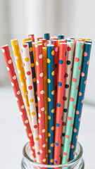 Colorful polka dot cocktail straws, vibrant party drink accessories, festive background with copy space