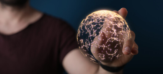 Close-up of a hand holding a glowing digital globe symbolizing global communication, connection, and technology, with a dark background. Ideal f