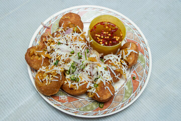 Fuchka, Pani Puri, a popular Indian street food. Crispy shells filled with savory goodness, paired with tangy tamarind water. Perfect for culinary features.