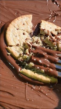 put cookies in chocolate cream, break cookies into pieces, chocolate close-up.
