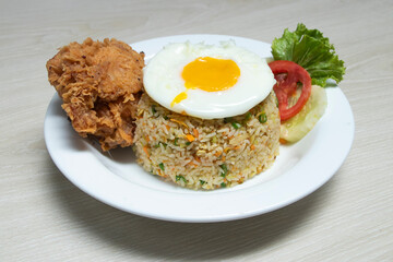 crispy fried chicken and flavorful fried rice crowned with a vibrant sunny side up egg, offering pure culinary delight.