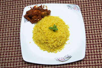 Bhuna khichuri with chicken masala or saffron rice alongside tender, flavorful chicken curry, ready to elevate any dining experience.