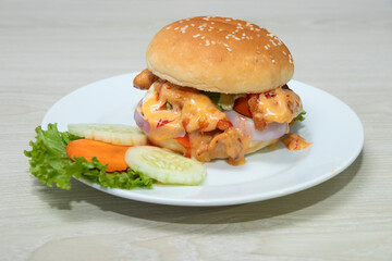 Classic Chicken burger, a feast for the senses with its juicy patty, creamy sauce, and vibrant fresh vegetables, ideal for enticing food lovers.