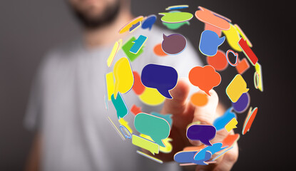 Concept of communication, global conversation, and social interaction. Hand touching a sphere made of speech bubbles, conveying connection and m