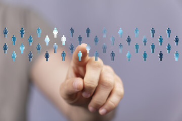 Choosing concept with hand pointing to person icons, people selection, teamwork, community, recruitment, or leadership concept.
