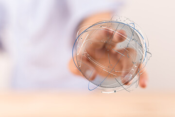 Abstract image of a person's hand holding a digitally generated globe. Representing concepts such as global connection, technology, and the digi