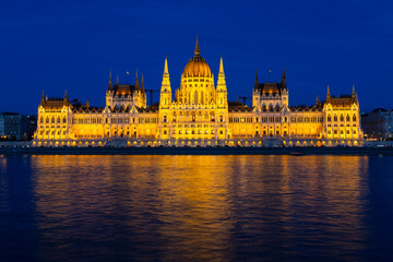 The Danube river and 1902 Gothic Revival style Parliament illuminated seen from Buda during the evening blue hour, Budapest, Hungary
