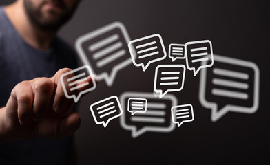 Hand interacting with floating message bubbles, representing digital communication, social media, and online interaction. Ideal for concepts rel