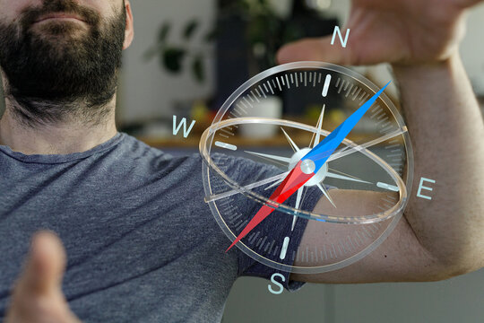 Person using compass for navigation and direction, exploring new journeys, finding ways, and traveling. Discover the right path. Guiding and ori