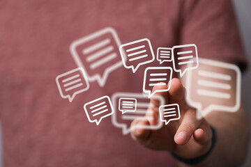 Person interacting with floating speech bubbles representing online communication and social media interaction, symbolizing conversation, connec