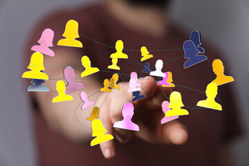 Image of hand touching a network of connected person icons, representing teamwork, communication,...