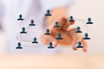Concept of social network and global business connections. Hand pointing to digital human network diagram with connections. Represents teamwork,