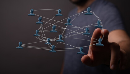 Abstract image showing a hand pointing to a network of connected people. Ideal for illustrating concepts of teamwork, communication and connecti