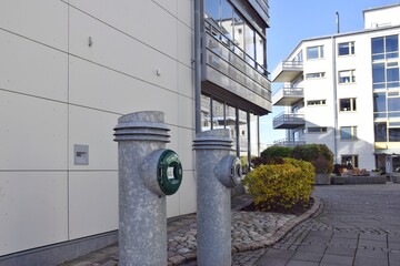 Separate underground waste containers near residential buildings, a recycling and eco-friendly approach to waste disposal, and waste separation in Sweden.