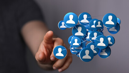 Concept of social networking or business network with hand pointing towards connected profile icons. Represents connection, communication, and c