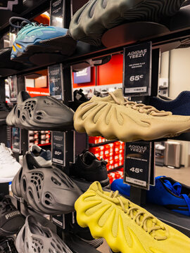 Bratislava, Slovakia, 9 June 2025: Adidas Yeezy sneakers in retail display. Adidas Yeezy and other designer sneakers displayed on shelves in fashion store